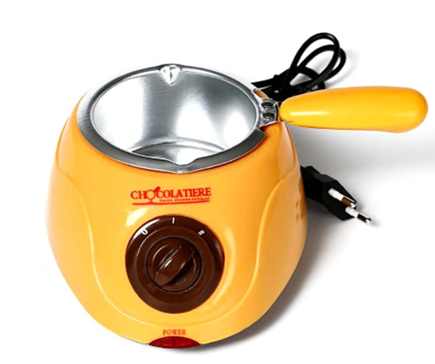 C - CHOCOLATERA - DERRITE CHOCOLATE (COLOR AMARILLO Y ROSADO). INCLUYE INSTRUMENTOS Y MOLDES. CON ENCHUFE. EN CAJA